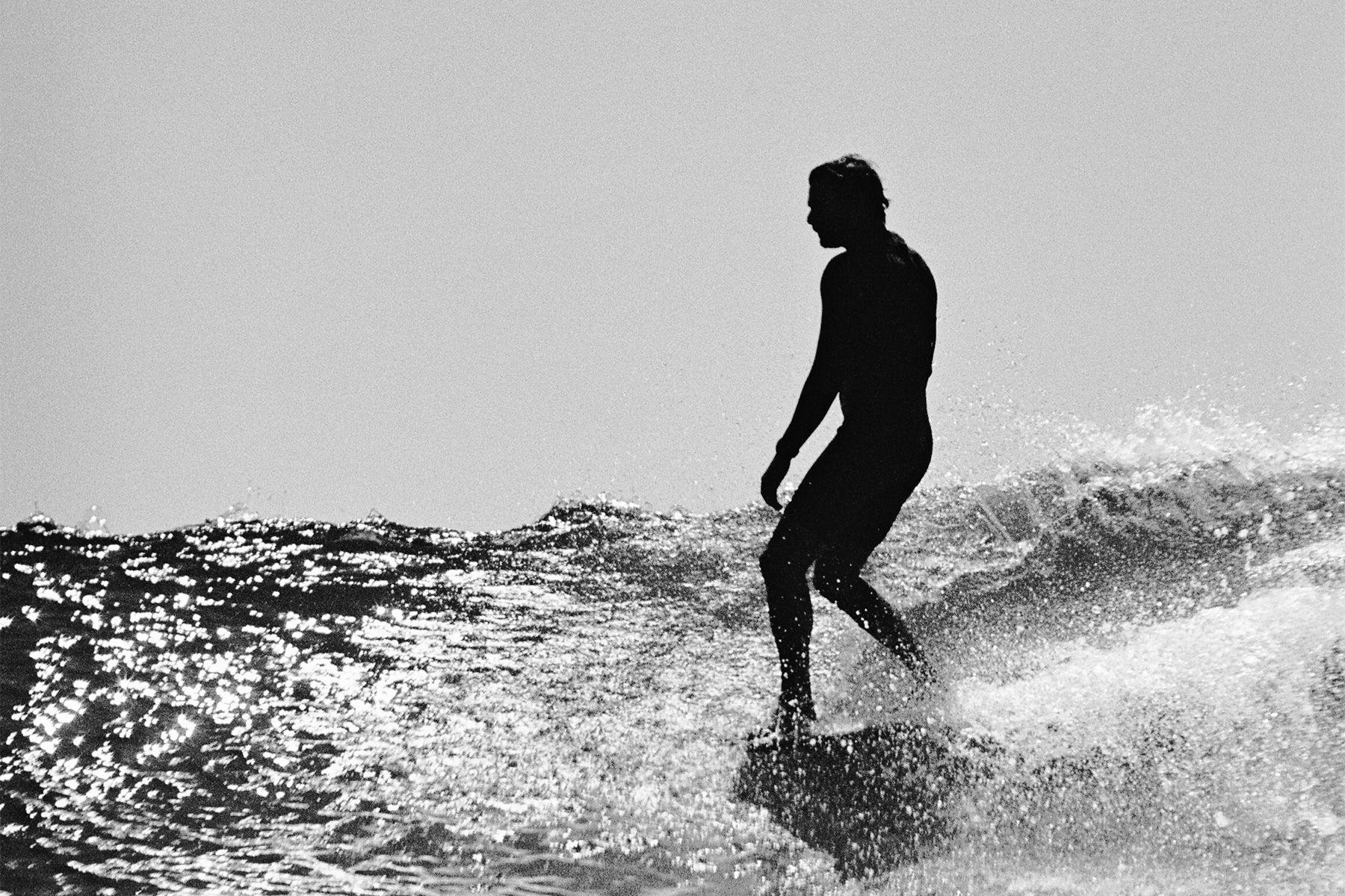 surfer noseriding at malibu, photographed on 35mm film using a nikonos camera by grant musso