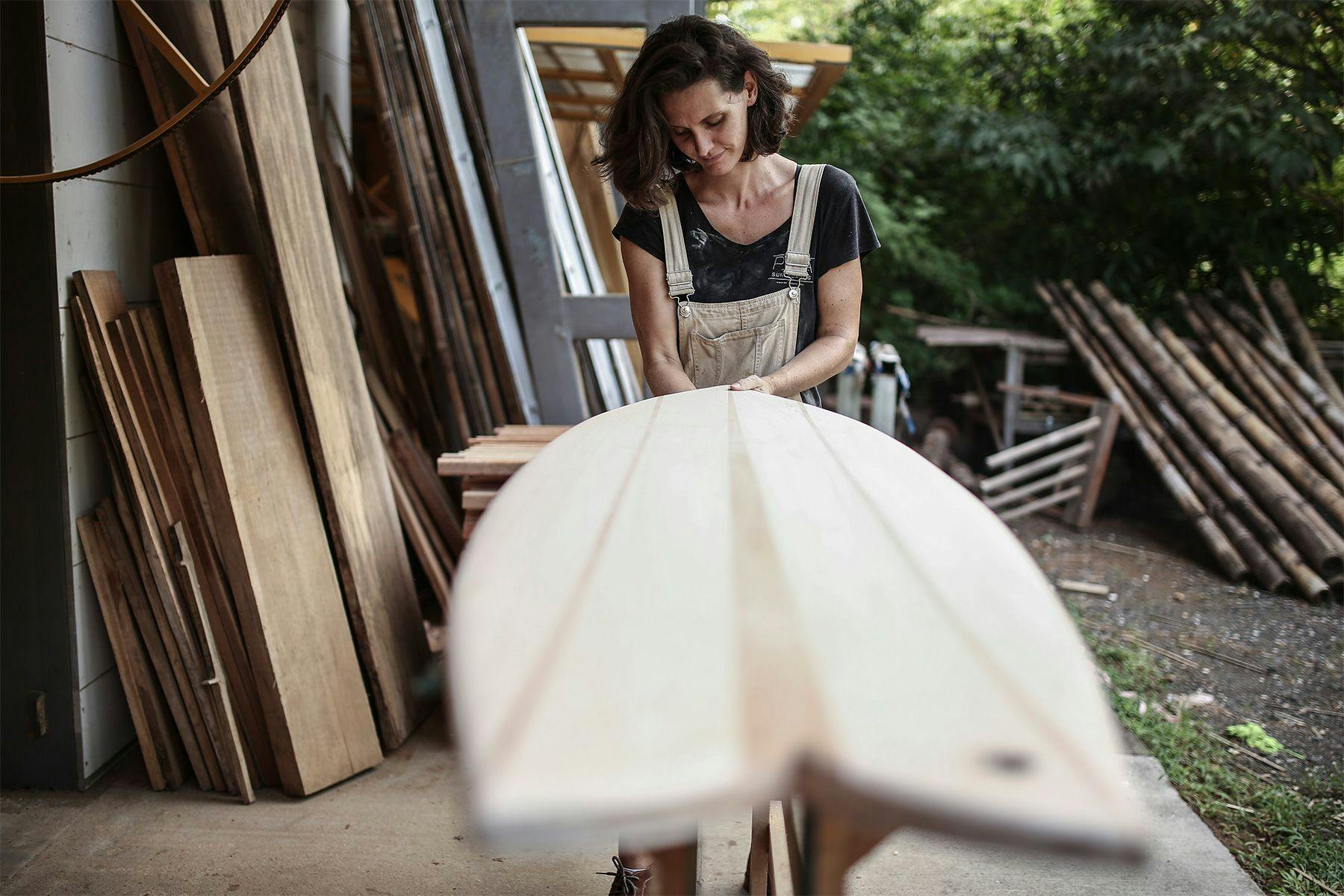 wooden surfboard maker marceline craig of pina surfboards in costa rica shaping a wooden fish