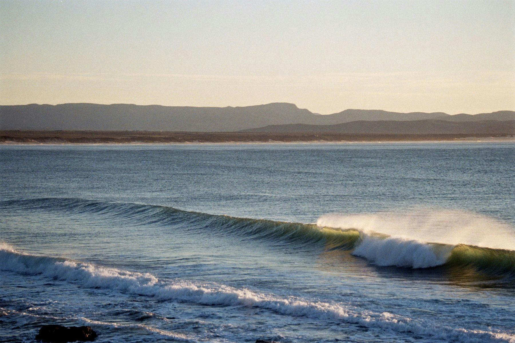 breaking wave at dawn at jeffreys bay, south africa