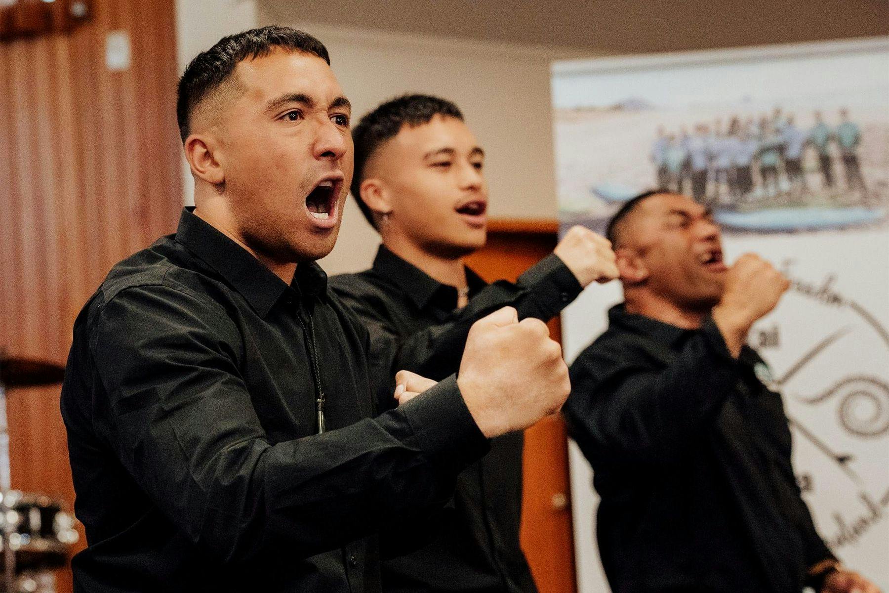 young maori men from the Tai Wātea surf therapy program perform a haka