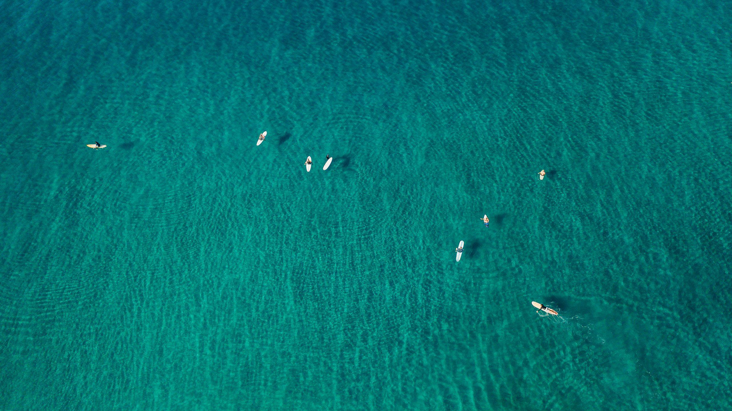 drone view of surfers sitting out back waiting for waves at surf simply in costa rica