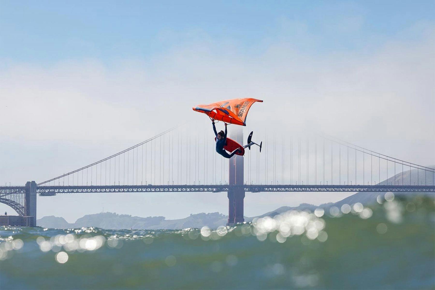 wing foiler in front of the golden gate bridge in san francisco by ana catarina