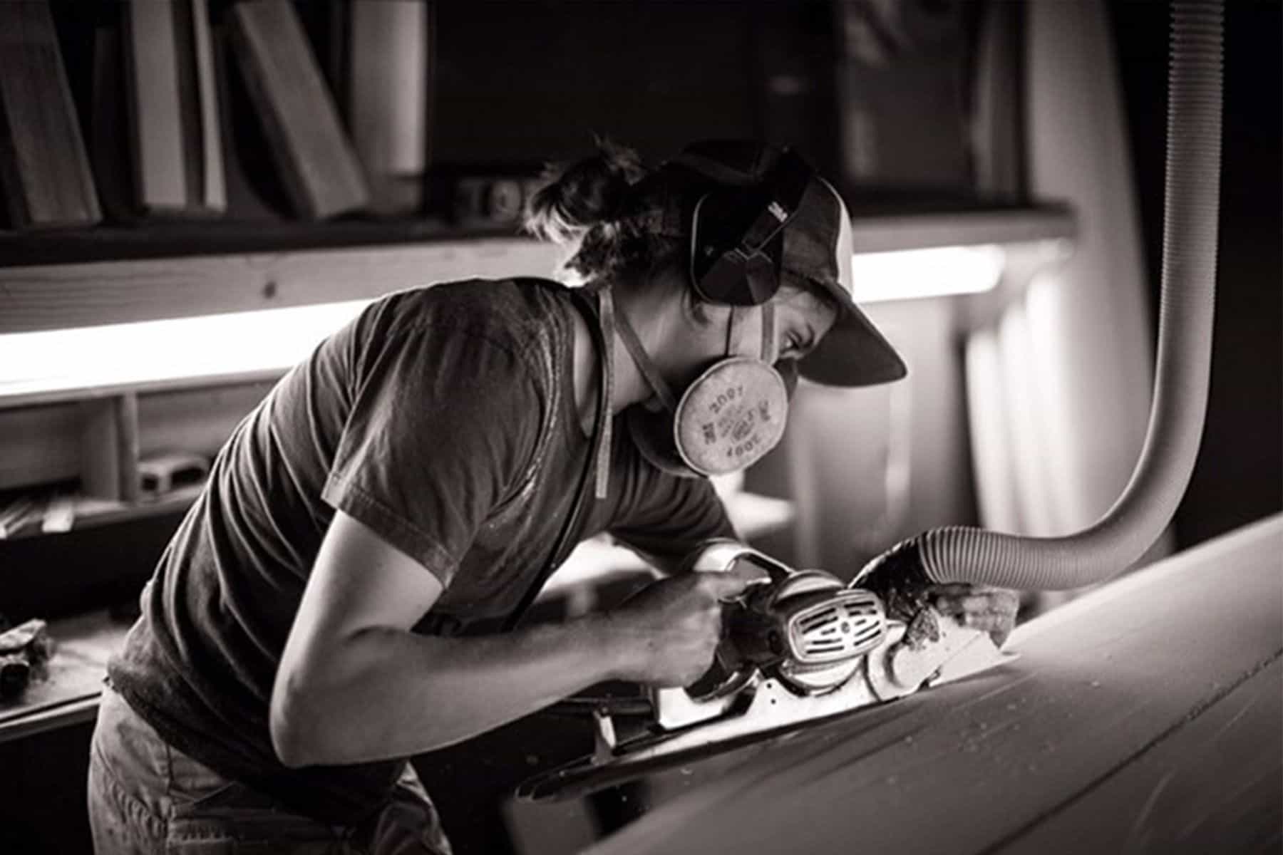 surfboard shaper Christine Brailsford Caro of furrow surfcraft shaping a surfboard by hand with a power planer