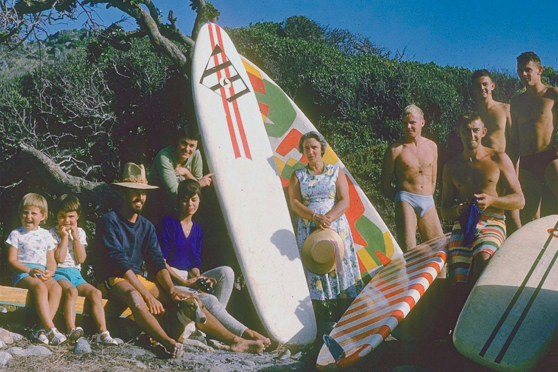 surfers john whitmore and dick metz with whitmore's family in south africa, 1961
