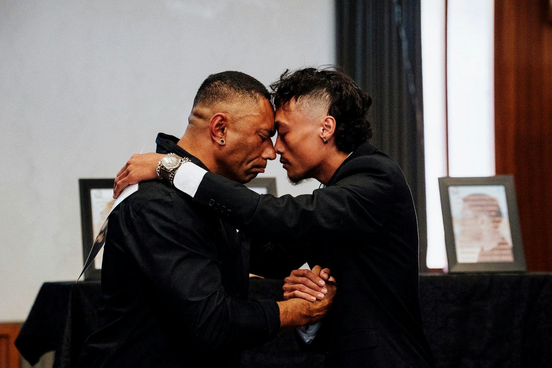 two maori men greet each other with a hongi