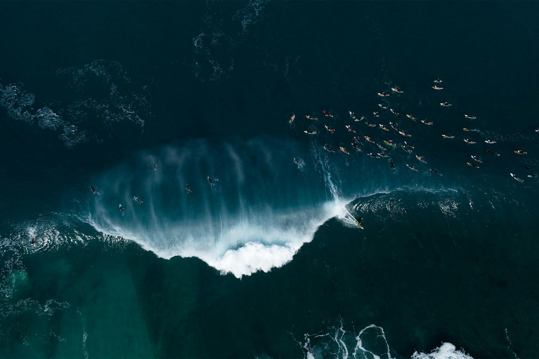 aerial view of surfers at pipeline by ana catarina