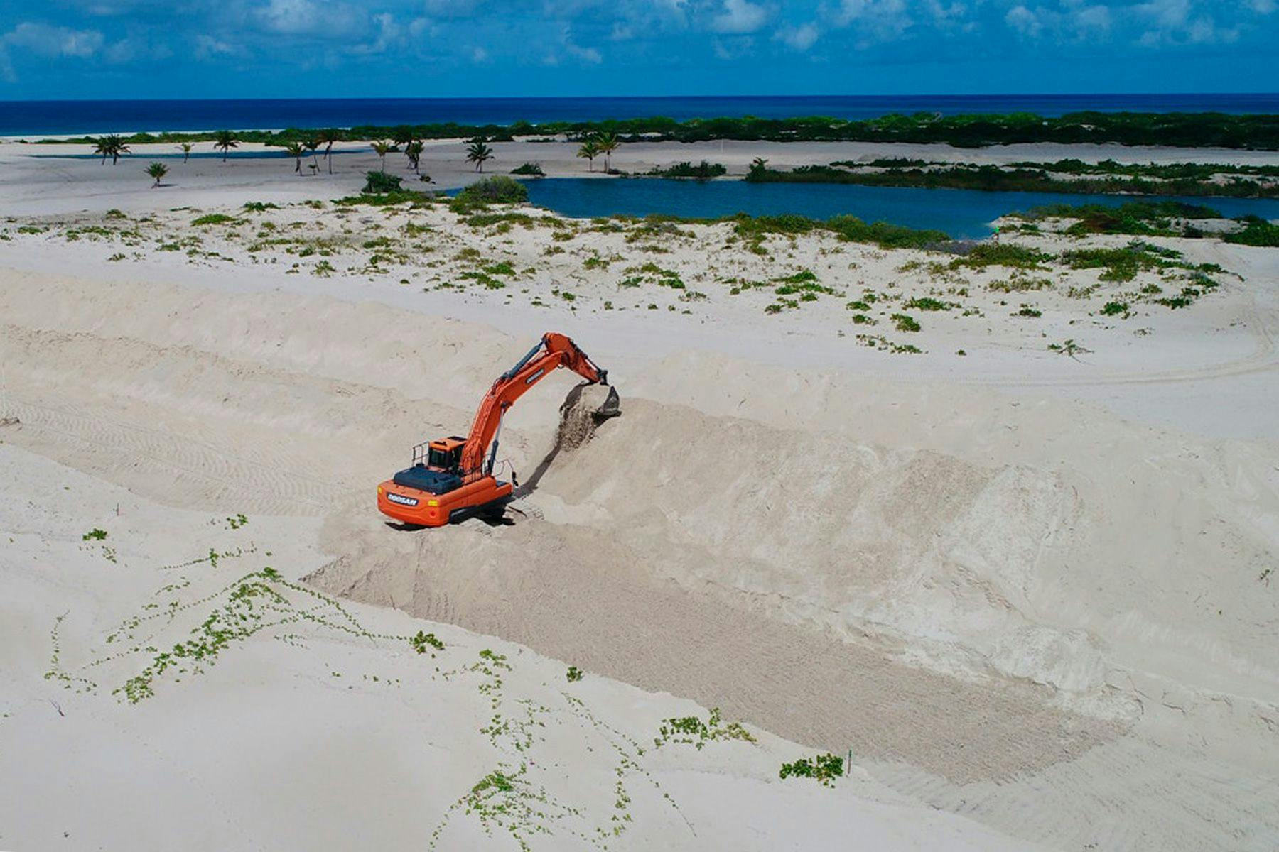 Digger on the beach at Palmetto Point, Barbuda. Image via GLAN.