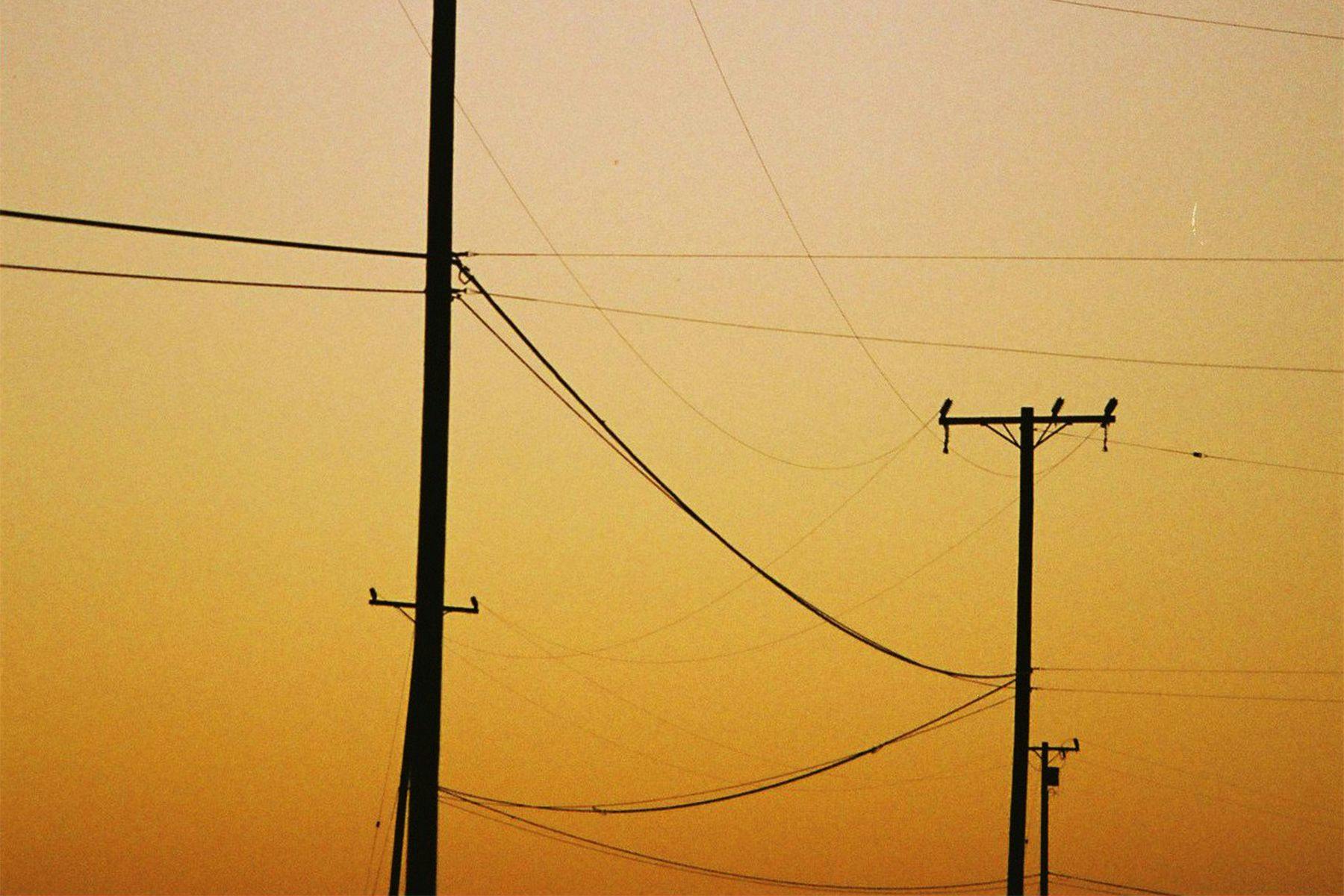 power lines silhouetted at sunset