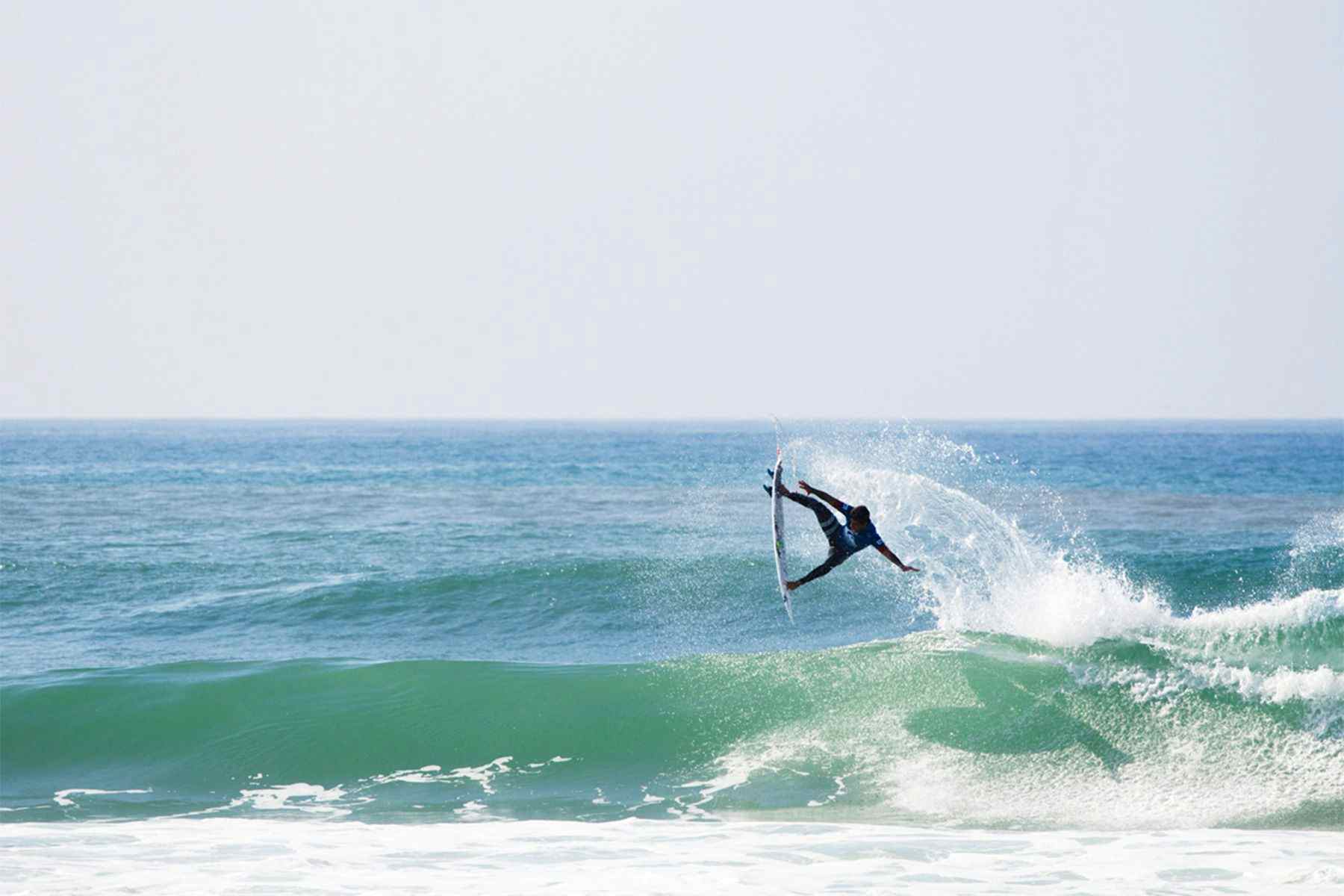 surfer miguel pupo boosting a large air reverse in the quiksilver pro surf contest in hossegor
