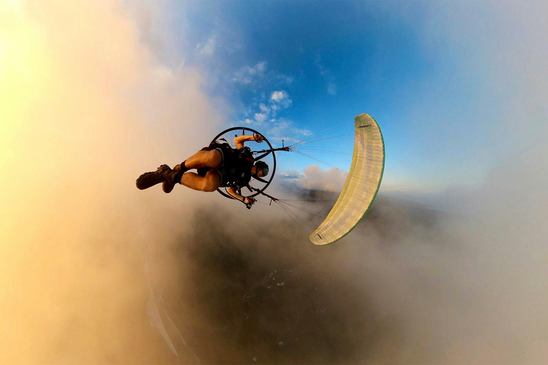 surf simply director of coaching harry knight flying his paramotor in the clouds